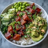 Golden-baked salmon cubes glisten atop fluffy jasmine rice in this Salmon Rice Bowl, garnished with creamy avocado slices and edamame.