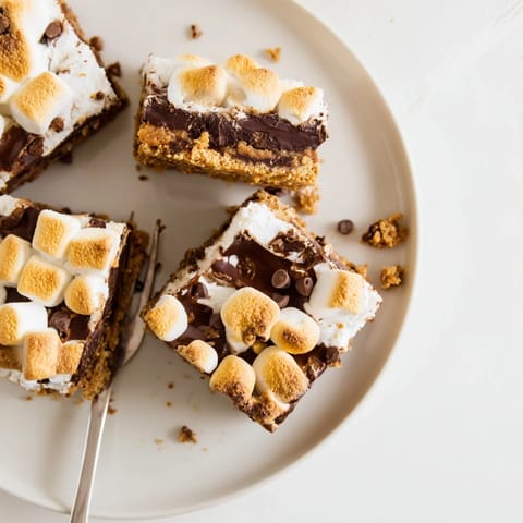A stack of four Smores Bars shows the graham cracker base and layered chocolate center.