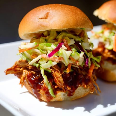 Savory BBQ Chicken Sliders layered with tender meat and creamy slaw on buns.