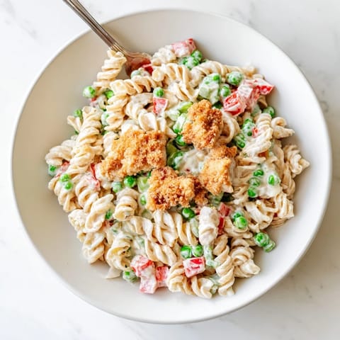 Crispy Chicken Ranch Pasta Salad features crunchy homemade breaded chicken, tender pasta, and colorful vegetables tossed in a cool, tangy buttermilk ranch dressing for a hearty lunch.