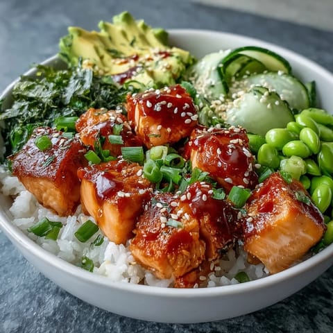 Golden baked salmon cubes sit on fluffy jasmine rice with edamame and avocado, ready for the Salmon Rice Bowl.