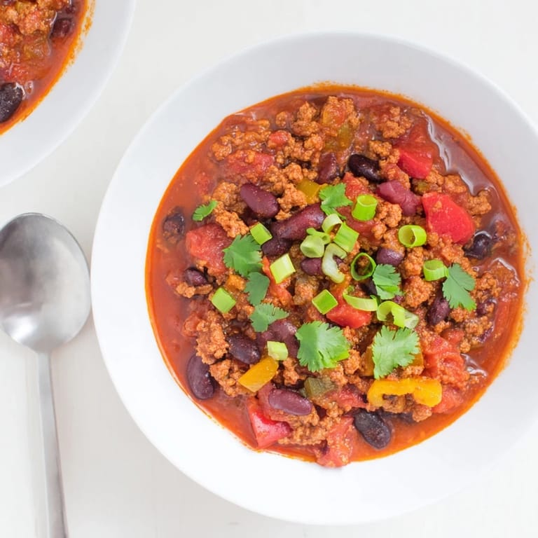 Hearty Turkey Chili simmering in a pot with rich tomato broth, black beans, and tender ground turkey for a cozy meal.