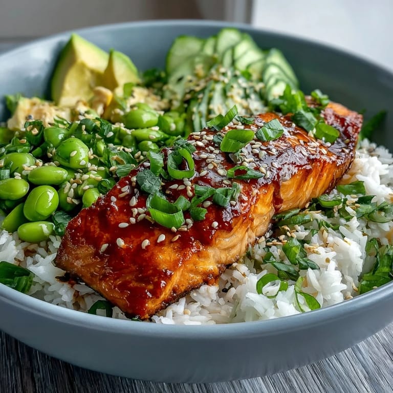 Drizzled with spicy mayo and sesame seeds, the vibrant honey sriracha salmon bowl tastes irresistible.